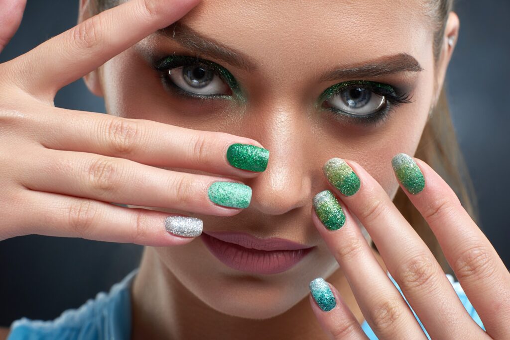 brunette-woman-with-shiny-manicure-and-green-makeu-2021-08-28-19-23-35-utc